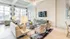 Bright and elegant living room with modern decor, plush seating, and large windows offering a stunning view. Ideal for relaxation and entertaining.
