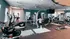 Modern fitness center with top-tier equipment, featuring exercise bikes, treadmills, and weight machines under stylish lighting.