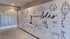 Chic apartment lobby featuring modern mailboxes and a playful Venice-themed mural with beach illustrations.