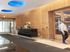 Elegant apartment lobby with modern design, featuring a sleek reception desk and contemporary lighting.