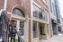 Inviting urban setting with charming brick exterior and iconic coffee shop, perfect for city lifestyle.