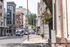 Charming urban street view with historic architecture, vibrant storefronts, and a bustling city atmosphere, ideal for city living enthusiasts.