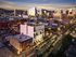 Stunning cityscape view showcasing a vibrant downtown with modern architecture illuminated at twilight, highlighting the hustle and charm of urban living.