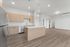 Modern open-concept kitchen with sleek cabinetry, stainless steel appliances, and elegant pendant lighting over a spacious island.