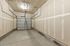 Spacious and clean garage with a modern paneled door and high ceiling, perfect for storage or parking.