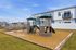 Inviting playground with modern structures in a spacious residential community setting.