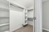Spacious, modern walk-in closet with built-in shelving and ample storage space.