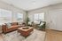 Bright and inviting living room with elegant leather sofa, plush armchairs, and modern decor, perfect for relaxation.