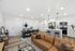 Modern open-concept living and dining area with a sleek kitchen, stylish seating, and elegant decor.