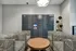Modern package locker area with chic patterned seating and stylish wooden table in a contemporary apartment building.
