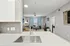 Modern open-concept living room with stylish kitchen, sleek countertops, and bright natural light creating an inviting atmosphere.