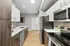 Modern kitchen showcasing sleek stainless steel appliances, elegant cabinetry, and a spacious countertop with a stylish backsplash.