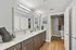 Modern bathroom with dual sinks, sleek wood cabinetry, and elegant decor accents creating a sophisticated ambiance.