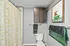 Chic bathroom with modern cabinet, playful art piece, and elegant shower curtain, exuding contemporary style and comfort.