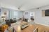 Chic living room with cozy sofas, vibrant decor, and ample natural light, perfect for modern living.