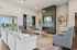 Inviting living room with plush seating, vibrant patterned rug, and modern fireplace creating a cozy ambiance. | Legacy at Crowley | Atlanta Apartments