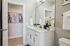 Chic bathroom with elegant white vanity, large mirror, and tasteful decor creating a modern and inviting atmosphere. | Legacy at Crowley | Atlanta Apartments