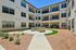Inviting residential courtyard featuring modern architecture, cozy outdoor seating, and landscaped greenery for relaxation. | Legacy at Crowley | Atlanta Apartments