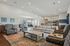 Inviting open-concept clubhouse with elegant seating, chic decor, and a modern kitchen, perfect for entertaining.