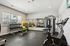 Bright and modern fitness center with state-of-the-art equipment, mirrored walls, and free weights, perfect for an energizing workout.