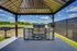 Chic outdoor grill pavilion with a sleek modern design, perfect for hosting BBQs amidst scenic nature views.