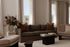 Elegant living room with plush sofas, floor-to-ceiling windows, and chic decor, featuring a stunning view and modern ambiance.