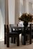 Elegant dining area with modern wooden table and chairs, surrounded by floor-to-ceiling curtains and adorned with a lush floral centerpiece.