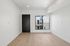 Bright and modern room with sleek wood flooring and a large window offering a tranquil view.