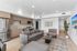 Sleek modern apartment with open-concept living area, stylish kitchen, and cozy seating, enhanced by bright natural light.