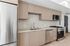 Modern kitchen with sleek stainless steel appliances, elegant cabinetry, and a stylish marble backsplash.