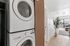 Modern apartment with in-unit washer and dryer, sleek hardwood floors, spacious living room with natural light, and a private balcony.