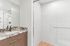 Modern bathroom featuring elegant marble countertop, spacious shower area, and sleek design.