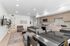 Contemporary open-plan living space with sleek kitchen, stylish furniture, and inviting decor, perfect for modern living.
