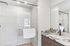 Elegant bathroom with a glass-enclosed shower and a stylish marble countertop, exuding modern luxury.