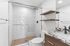 Contemporary bathroom with sleek glass-enclosed shower, modern fixtures, and elegant marble countertop.