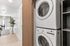 Bright modern apartment with in-unit washer and dryer, open living space, and elegant natural wood flooring.