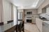 Modern kitchen with sleek cabinetry, stainless steel appliances, and elegant dining area, perfect for culinary enthusiasts.