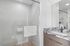 Sleek modern bathroom featuring a glass-enclosed shower and a stylish marble countertop with elegant fixtures.