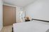 Chic bedroom with sleek wardrobe and modern decor, offering a serene and stylish living space.