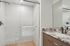 Elegant bathroom featuring a luxurious marble countertop and modern glass-enclosed shower.