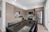 Modern kitchen with sleek cabinetry, stainless steel appliances, and a stylish dining area bathed in natural light.