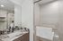 Modern bathroom with sleek marble countertop, elegant fixtures, and spacious glass shower, offering a luxurious and tranquil retreat.