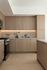 Modern kitchen with elegant wood cabinetry, sleek countertops, and stainless steel appliances.