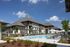 Pool with building behind and lounge chairs