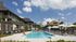 Pool area with lounge chairs and building behind