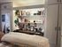 Inviting home office with built-in shelving filled with books and decor, reflecting a creative and organized workspace.
