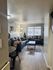 Inviting living room with grey sofas, festive decor, and modern furniture.