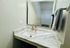 Luxurious marble bathroom vanity with sleek faucet and stylish mirror.