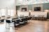 Elegant dining area with plush seating, stylish decor, and natural light, perfect for entertaining in a modern apartment.