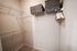 Spacious walk-in closet with ample shelving and storage space, featuring neatly organized hangers and stylish wicker baskets for a modern touch.